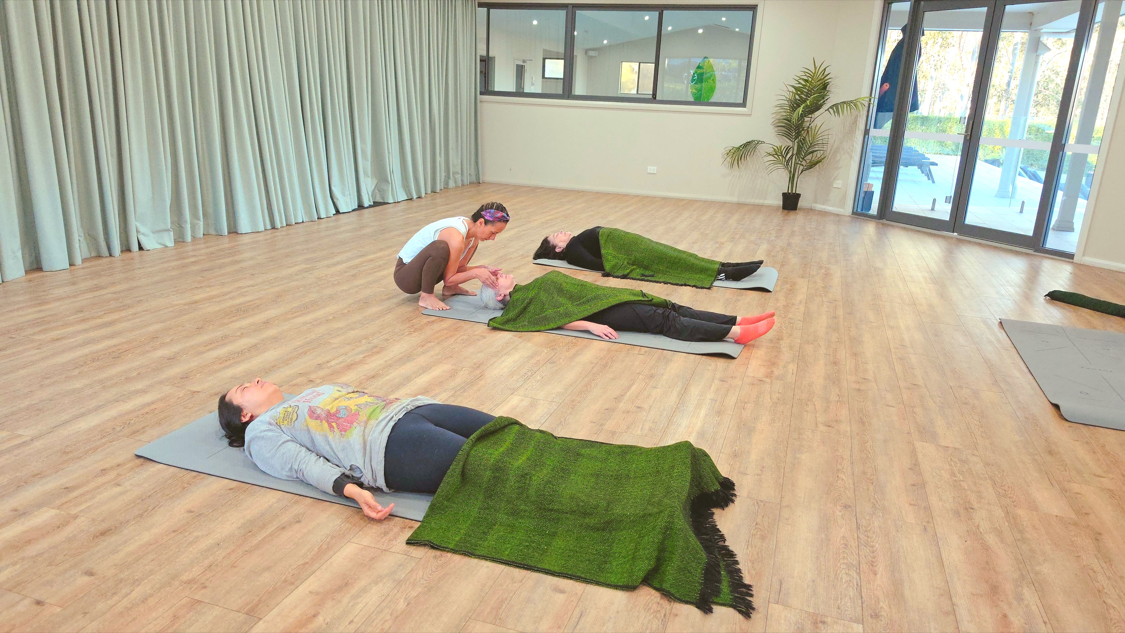 Three people practising guided rhythmic movement during a Deep Reset Experience workshop